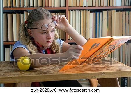 The girl with green apple and a book. View Large Photo Image Stock Image - The girl with green apple and a book.. Fotosearch