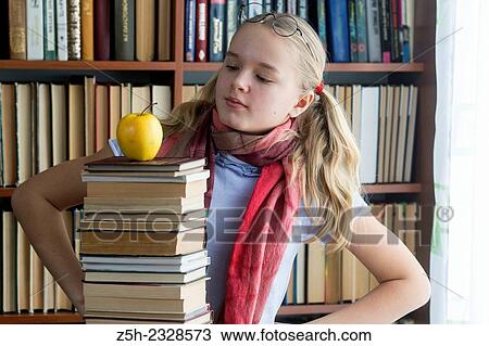 The girl with green apple and a book. View Large Photo Image Stock Image - The girl with green apple and a book.. Fotosearch