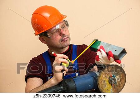 Stock Photograph - The installer performs the order.. Fotosearch