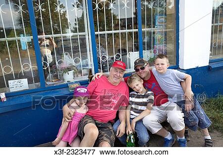 Three generations resting at little store after biking trails thru forest. Mala Wola Central Poland. View Large Photo Image Stock Photo - Three generations resting at little store after biking trails thru forest. Mala Wola Central Poland.. Fotosearch
