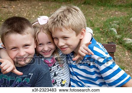Three happy Polish sibling children hugging to help their grandfather Steve's stock photo business. Zawady Poland. View Large Photo Image Stock Image - Three happy Polish sibling children hugging to help their grandfather Steve's stock photo business. Zawady Poland.. Fotosearch