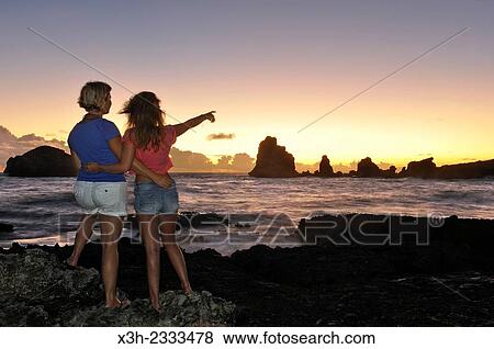 two young women watching sunrise at Pointe des Chateaux, Grande-Terre, Guadeloupe, overseas region of France, Leewards Islands, Lesser Antilles, Caribbean. View Large Photo Image Stock Photo - two young women watching sunrise at Pointe des Chateaux, Grande-Terre, Guadeloupe, overseas region of France, Leewards Islands, Lesser Antilles, Caribbean.. Fotosearch