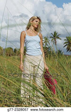 Stock Photo - Usa. Florida. Miami Beach. Young woman on the beach.. Fotosearch