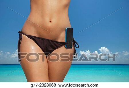 Usa. Florida. Miami Beach. Young woman on the beach with smartphone in the swimsuit. View Large Photo Image Stock Photo - Usa. Florida. Miami Beach. Young woman on the beach with smartphone in the swimsuit.. Fotosearch