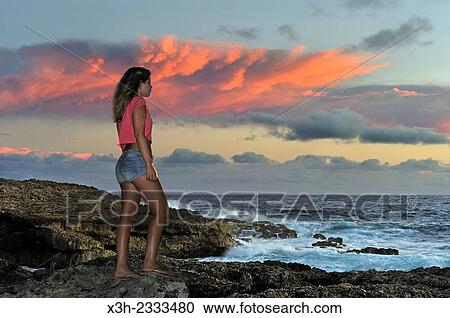 young girl admiring sunrise at Pointe des Chateaux, Grande-Terre, Guadeloupe, overseas region of France, Leewards Islands, Lesser Antilles, Caribbean. View Large Photo Image Stock Image - young girl admiring sunrise at Pointe des Chateaux, Grande-Terre, Guadeloupe, overseas region of France, Leewards Islands, Lesser Antilles, Caribbean.. Fotosearch