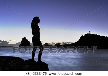 Stock Photograph - young girl admiring sunrise at Pointe des Chateaux, Grande-Terre, Guadeloupe, overseas region of France, Leewards Islands, Lesser Antilles, Caribbean.. Fotosearch