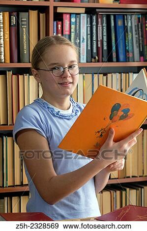 Stock Photo - Young girl reading fiction.. Fotosearch