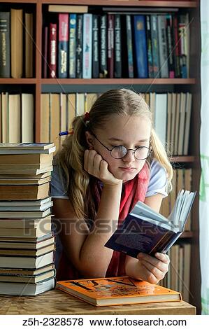 Stock Photo - Young girl reading fiction.. Fotosearch