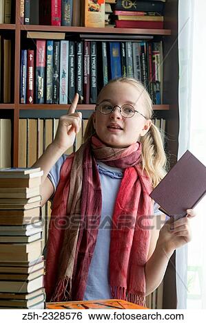 Stock Photograph - Young girl reading fiction.. Fotosearch