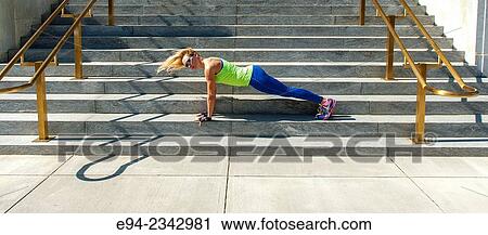 39 year old blond woman wearing fitness clothing doing push ups on the steps of a building in an urban settiing. View Large Photo Image Stock Image - 39 year old blond woman wearing fitness clothing doing push ups on the steps of a building in an urban settiing.. Fotosearch
