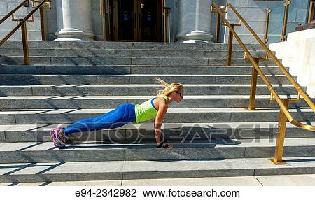 39 year old blond woman wearing fitness clothing doing push ups on the steps of a building in an urban settiing. View Large Photo Image Stock Image - 39 year old blond woman wearing fitness clothing doing push ups on the steps of a building in an urban settiing.. Fotosearch