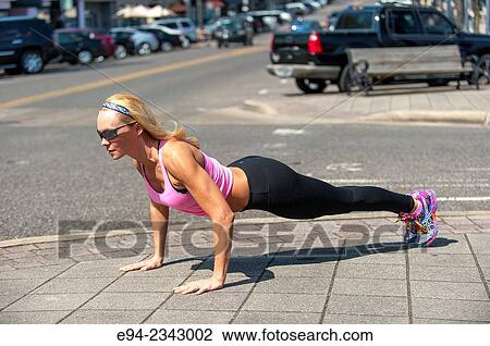 39 year old blond woman wearing fitness clothing doing push ups on a sidewalk in an urban settiing. View Large Photo Image Stock Image - 39 year old blond woman wearing fitness clothing doing push ups on a sidewalk in an urban settiing.. Fotosearch
