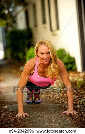 39 year old blond woman wearing fitness clothing doing push ups on a sidewalk in an urban settiing. View Large Photo Image Stock Photography - 39 year old blond woman wearing fitness clothing doing push ups on a sidewalk in an urban settiing.. Fotosearch