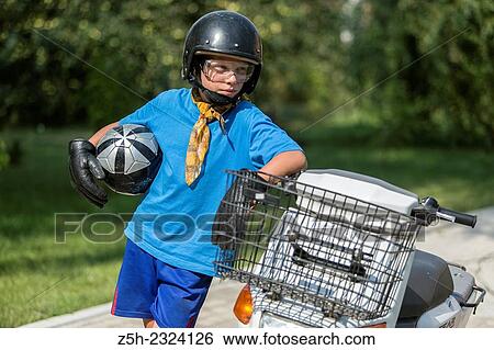 A boy of eleven years on a scooter. View Large Photo Image Stock Photograph - A boy of eleven years on a scooter.. Fotosearch