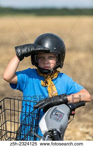 Stock Photography - A boy of eleven years on a scooter.. Fotosearch