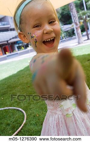 A happy 3 years old girl with face painting pointing to the camera View Large Photo Image Stock Image - A happy 3 years old girl with face painting pointing to the camera. Fotosearch