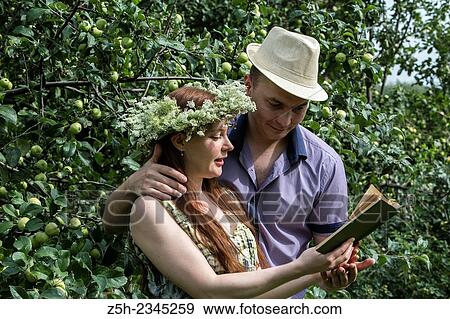 A man with a girl in a summer park reading a book. View Large Photo Image Stock Photo - A man with a girl in a summer park reading a book.. Fotosearch
