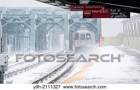 A subway train departs the Smith Street-9th Street station on the elevated portion of the IND line in the Gowanus neighborhood of Brooklyn in New York during a snow storm View Large Photo Image Stock Photo - A subway train departs the Smith Street-9th Street station on the elevated portion of the IND line in the Gowanus neighborhood of Brooklyn in New York during a snow storm. Fotosearch