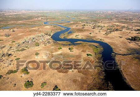 Aerial view of the Okavango Delta, Botswana. The vast inland delta is formed from the Okavango River. View Large Photo Image Stock Photo - Aerial view of the Okavango Delta, Botswana. The vast inland delta is formed from the Okavango River.. Fotosearch