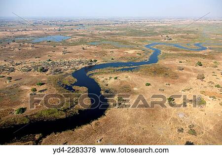 Aerial view of the Okavango Delta, Botswana. The vast inland delta is formed from the Okavango River. View Large Photo Image Stock Photo - Aerial view of the Okavango Delta, Botswana. The vast inland delta is formed from the Okavango River.. Fotosearch