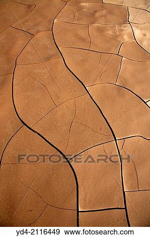 Stock Photo - After the rains, the hot sun drys the mud cracking it. Skeleton Coast Park, Namibia.. Fotosearch