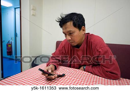 An Indonesian seaman or sailor on the container-vessel MV Flintercape, during a journey from Rotterdam, Netherlands, to Sundsvall, Sweden. View Large Photo Image Stock Image - An Indonesian seaman or sailor on the container-vessel MV Flintercape, during a journey from Rotterdam, Netherlands, to Sundsvall, Sweden.. Fotosearch