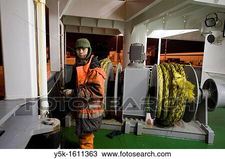 Stock Image - An Indonesian Seaman or sailor on the container-vessel MV Flintercape, during a journey from Rotterdam, Netherlands, to Sundsvall, Sweden.. Fotosearch