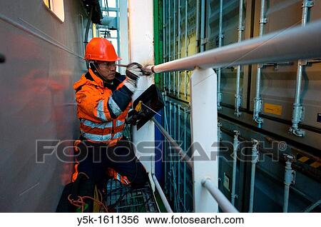 An Indonesian seaman or sailor on the container-vessel MV Flintercape, during a journey from Rotterdam, Netherlands, to Sundsvall, Sweden. View Large Photo Image Stock Photograph - An Indonesian seaman or sailor on the container-vessel MV Flintercape, during a journey from Rotterdam, Netherlands, to Sundsvall, Sweden.. Fotosearch