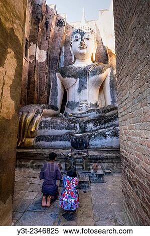 Asia. Thailand, Sukhothai (old capital of Siam), classified as a World UNESCO Heritage. Wat Si Chum. Praying front of the Buddha statue. View Large Photo Image Stock Photography - Asia. Thailand, Sukhothai (old capital of Siam), classified as a World UNESCO Heritage. Wat Si Chum. Praying front of the Buddha statue.. Fotosearch