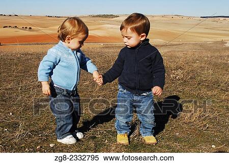 Stock Photography - Baby girl and baby boy in the field, Spain.. Fotosearch
