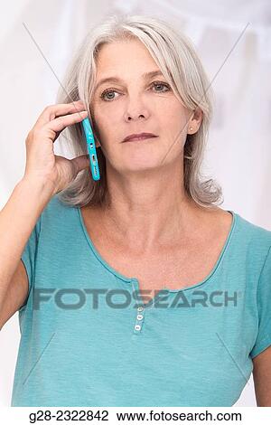 Beautiful mature woman using a blue i-phone View Large Photo Image Stock Image - Beautiful mature woman using a blue i-phone. Fotosearch
