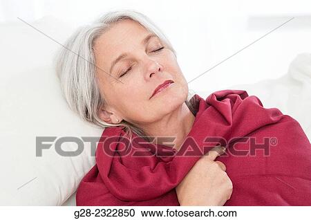 Beautiful mature woman, wrapped in a red shawl, asleep on a sofa View Large Photo Image Stock Image - Beautiful mature woman, wrapped in a red shawl, asleep on a sofa. Fotosearch