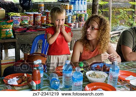 Bokor National Park. Cambodia. Travel with children's. Mother eating with her daughter. Privileged place to observe the nearby Vietnamese island of Phu Quoc. View Large Photo Image Stock Photo - Bokor National Park. Cambodia. Travel with children's. Mother eating with her daughter. Privileged place to observe the nearby Vietnamese island of Phu Quoc.. Fotosearch