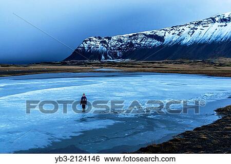 Boy Standing On A Lake, near Hofn, Iceland. View Large Photo Image Stock Photograph - Boy Standing On A Lake, near Hofn, Iceland.. Fotosearch