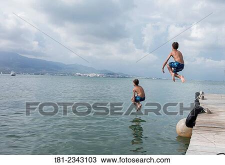 boy throwing himself into the sea, San Carlos de la Rapita, Tarragona View Large Photo Image Stock Image - boy throwing himself into the sea, San Carlos de la Rapita, Tarragona. Fotosearch