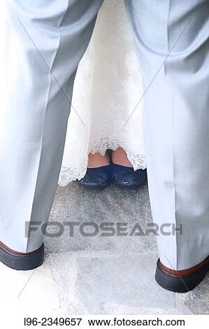 bride and groom facing eachother, showing blue wedding shoes View Large Photo Image Stock Photo - bride and groom facing eachother, showing blue wedding shoes. Fotosearch