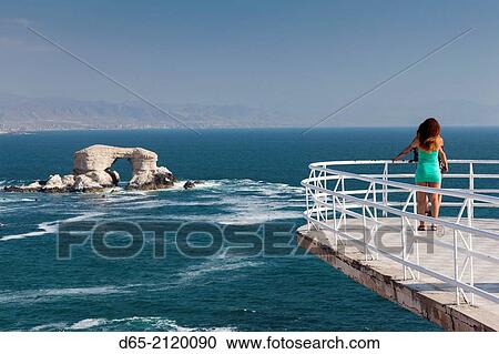 Stock Image - Chile, Antofagasta, La Portada rock formation with visitors.. Fotosearch
