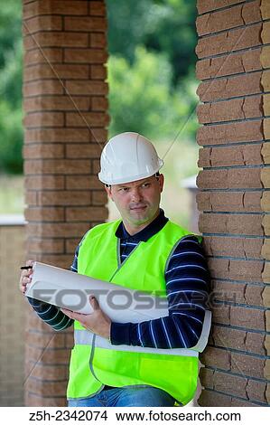 Picture - Civil engineer on the construction of a house.. Fotosearch