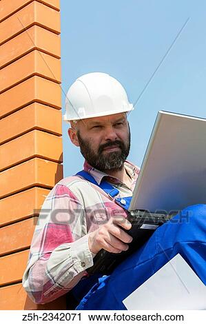 Civil engineer on the construction of a house. View Large Photo Image Stock Image - Civil engineer on the construction of a house.. Fotosearch