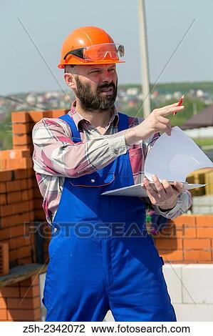 Civil engineer on the construction of a house. View Large Photo Image Stock Image - Civil engineer on the construction of a house.. Fotosearch
