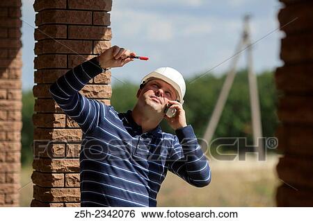 Civil engineer on the construction of a house. View Large Photo Image Stock Photograph - Civil engineer on the construction of a house.. Fotosearch