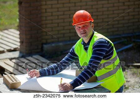 Civil engineer on the construction of a house. View Large Photo Image Stock Photography - Civil engineer on the construction of a house.. Fotosearch