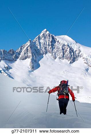 Stock Image - Climber in the Alps in winter, Monte Rosa massif, Piedmont, Italy. Fotosearch