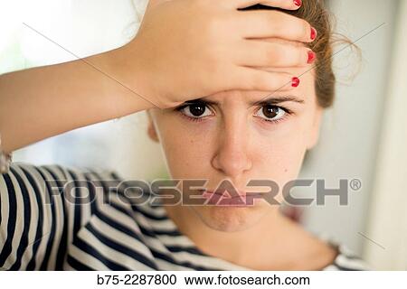 Closeup of a teenage girl with a hand on her forehead and expression fed up and tired View Large Photo Image Stock Image - Closeup of a teenage girl with a hand on her forehead and expression fed up and tired. Fotosearch