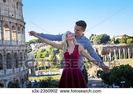 Stock Image - Couple at the Roman Colosseum in Rome Italy.. Fotosearch