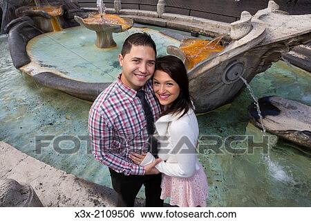 Stock Photograph - Couple at the Spanish steps water fountain. Rome, Italy.. Fotosearch