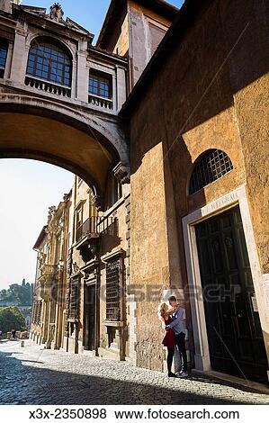 Stock Photo - Couple by Piazza del Campidoglio in Rome, Italy.. Fotosearch