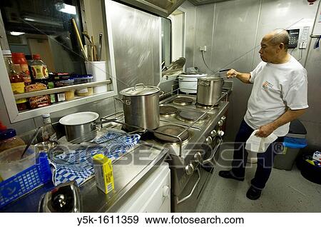 Stock Photo - During the voyage of the MV Flintercape from Rotterdam, Netherlands to Sundsvall, Sweden, this Indonesian cook takes care of all the food and meals on board. Fotosearch