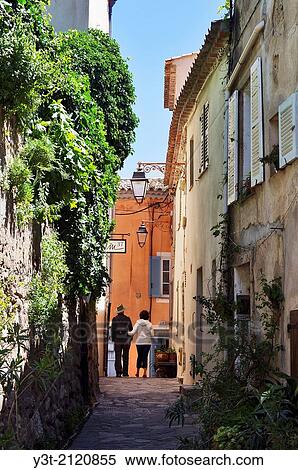 Europe, France, Var. Ramatuelle. Couple walking in a typical alley in the village. View Large Photo Image Stock Photography - Europe, France, Var. Ramatuelle. Couple walking in a typical alley in the village.. Fotosearch