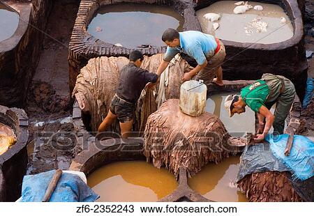 Stock Image - Fez Morocco old Tannery called Chouara Tannery which is almost 1000 years old from above of tannery vats with color dyes.. Fotosearch
